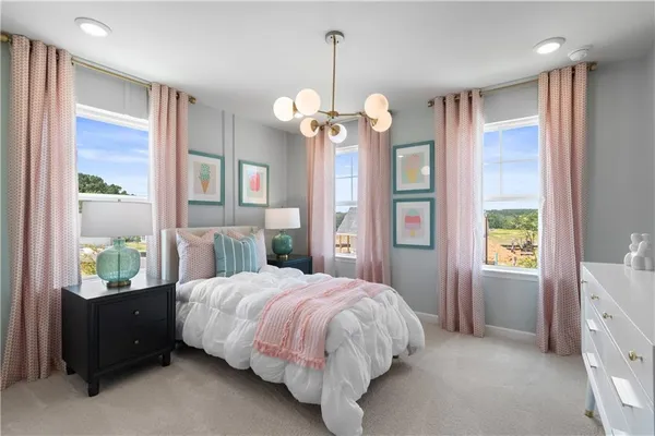 a bedroom with a bed couch and window