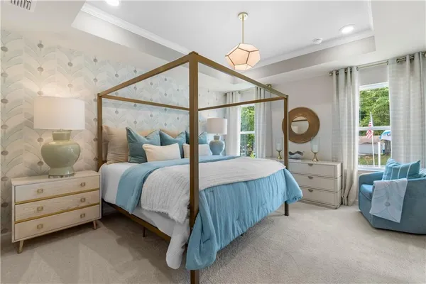 a bedroom with a bed couch and a window