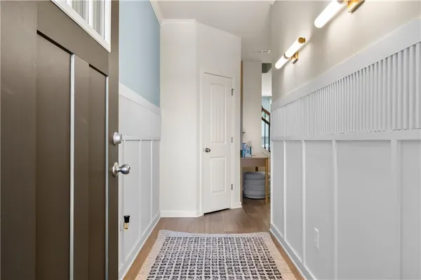 a view of a hallway view with wooden floor and staircase