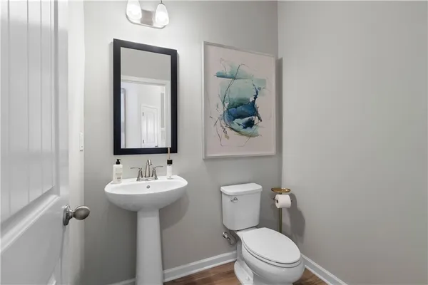 a kitchen with stainless steel appliances granite countertop a refrigerator a stove a sink dishwasher a dining table and chairs with wooden floor