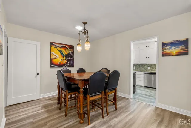 a kitchen with granite countertop white cabinets and stainless steel appliances