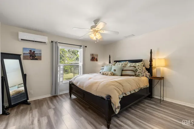 a bedroom with a large bed and a window