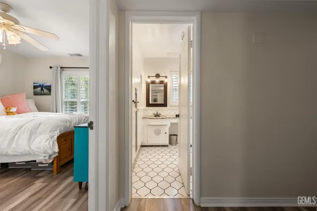 a bedroom with a bed and a flat tv screen on dresser