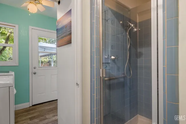 a bedroom with a bed and a ceiling fan