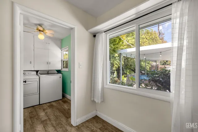 a view of backyard with swimming pool and seating space