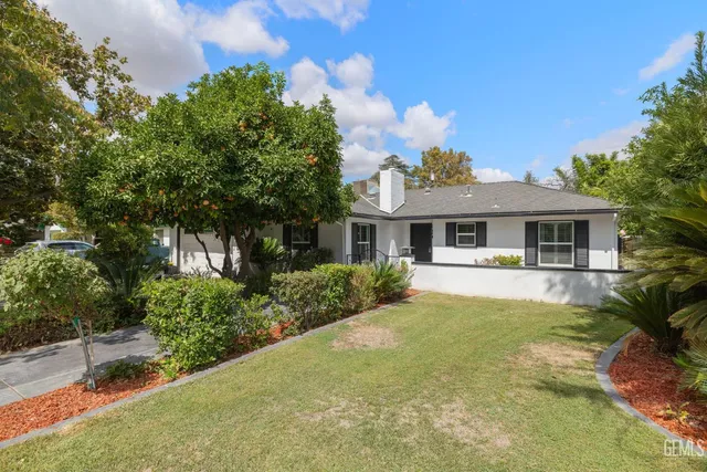 a front view of house with yard and green space