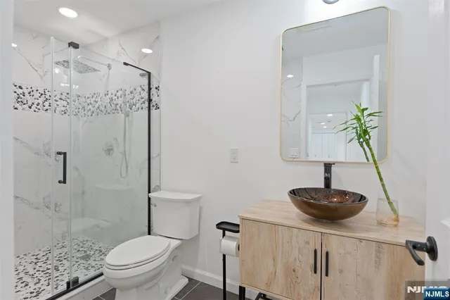 a bathroom with a toilet a sink and shower