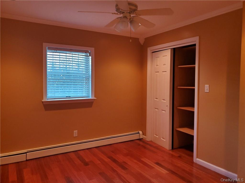 315 Washington Avenue, Unit 1 New Rochelle, NY 10801 - Photo 16 of 29 a view of an empty room with a window and wooden floor