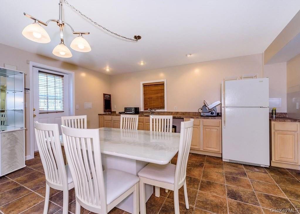 315 Washington Avenue, Unit 1 New Rochelle, NY 10801 - Photo 18 of 29 a view of a dining room with furniture and a chandelier