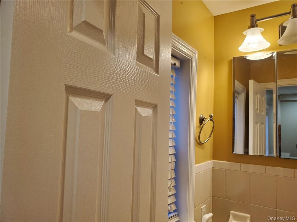 315 Washington Avenue, Unit 1 New Rochelle, NY 10801 - Photo 20 of 29 a bathroom with a mirror and a shower