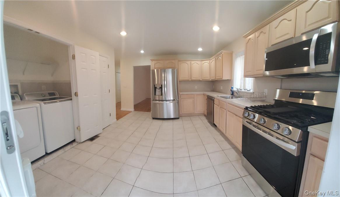 315 Washington Avenue, Unit 1 New Rochelle, NY 10801 - Photo 2 of 29 a kitchen with stainless steel appliances granite countertop a stove top oven a sink a refrigerator and cabinets