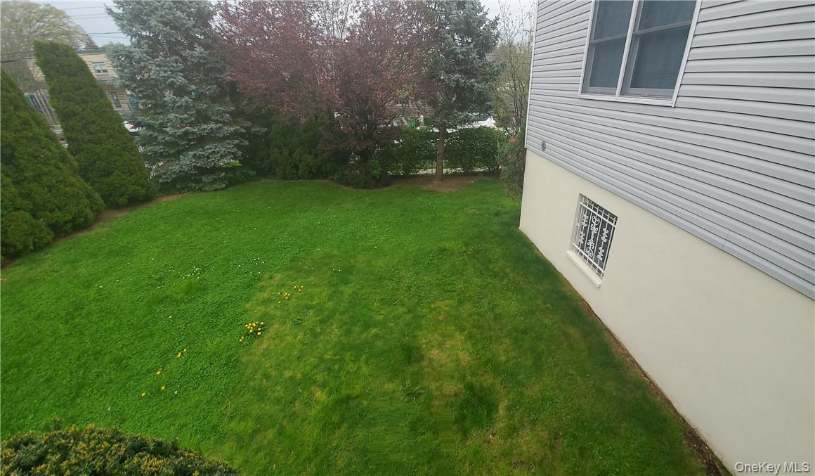 315 Washington Avenue, Unit 1 New Rochelle, NY 10801 - Photo 29 of 29 a view of a backyard with plants and large trees