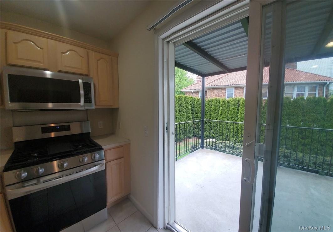 315 Washington Avenue, Unit 1 New Rochelle, NY 10801 - Photo 5 of 29 a view of a kitchen from a living room