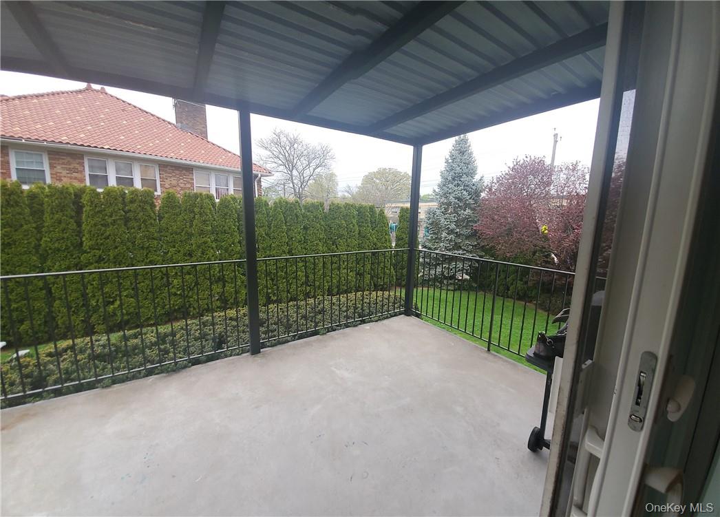 315 Washington Avenue, Unit 1 New Rochelle, NY 10801 - Photo 6 of 29 a view of a glass door and a yard from a balcony