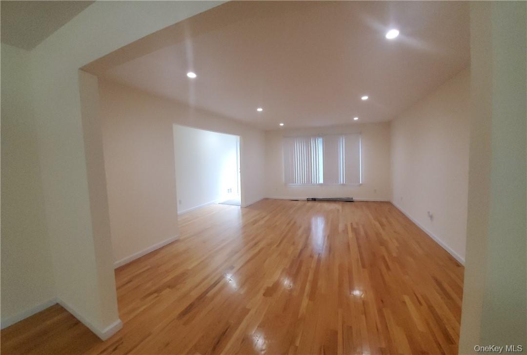 315 Washington Avenue, Unit 1 New Rochelle, NY 10801 - Photo 9 of 29 a view of empty room with wooden floor and fan