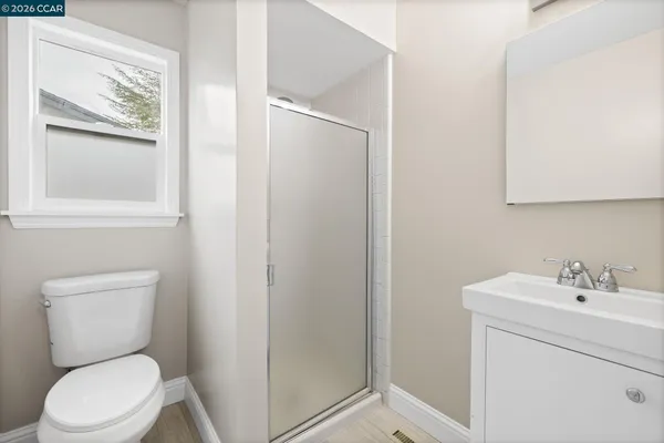 a white toilet sitting next to a bathroom sink
