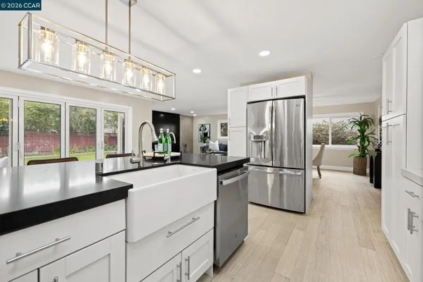 a kitchen with a refrigerator and a sink