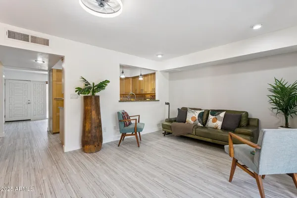 a living room with furniture and wooden floor