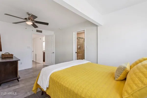 a bedroom with a bed and dresser