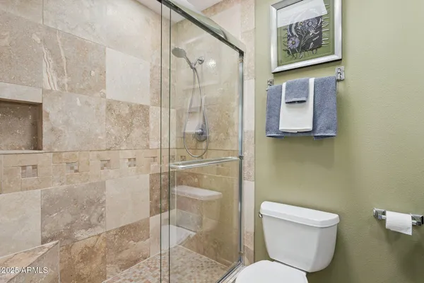 a white toilet sitting next to a bathroom sink