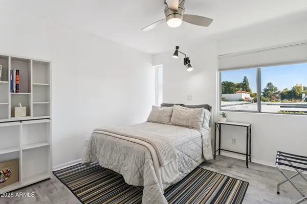 a bedroom with a bed and a window