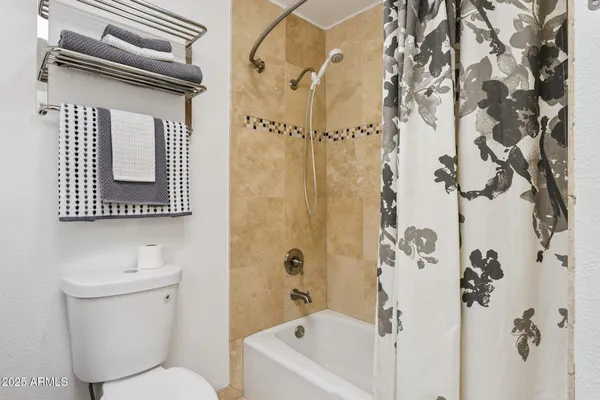 a bathroom with a toilet sink and shower