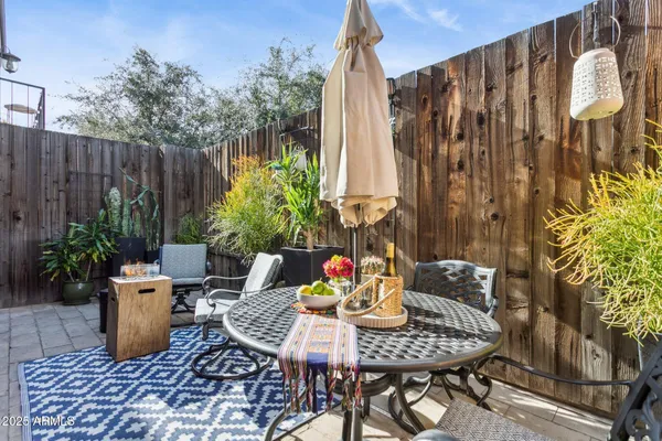 a view of outdoor dining space with a table and chairs