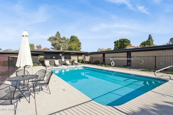 a view of a swimming pool with seating space