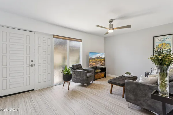 a living room with furniture and a potted plant