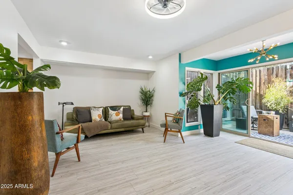 a living room with furniture and a potted plant