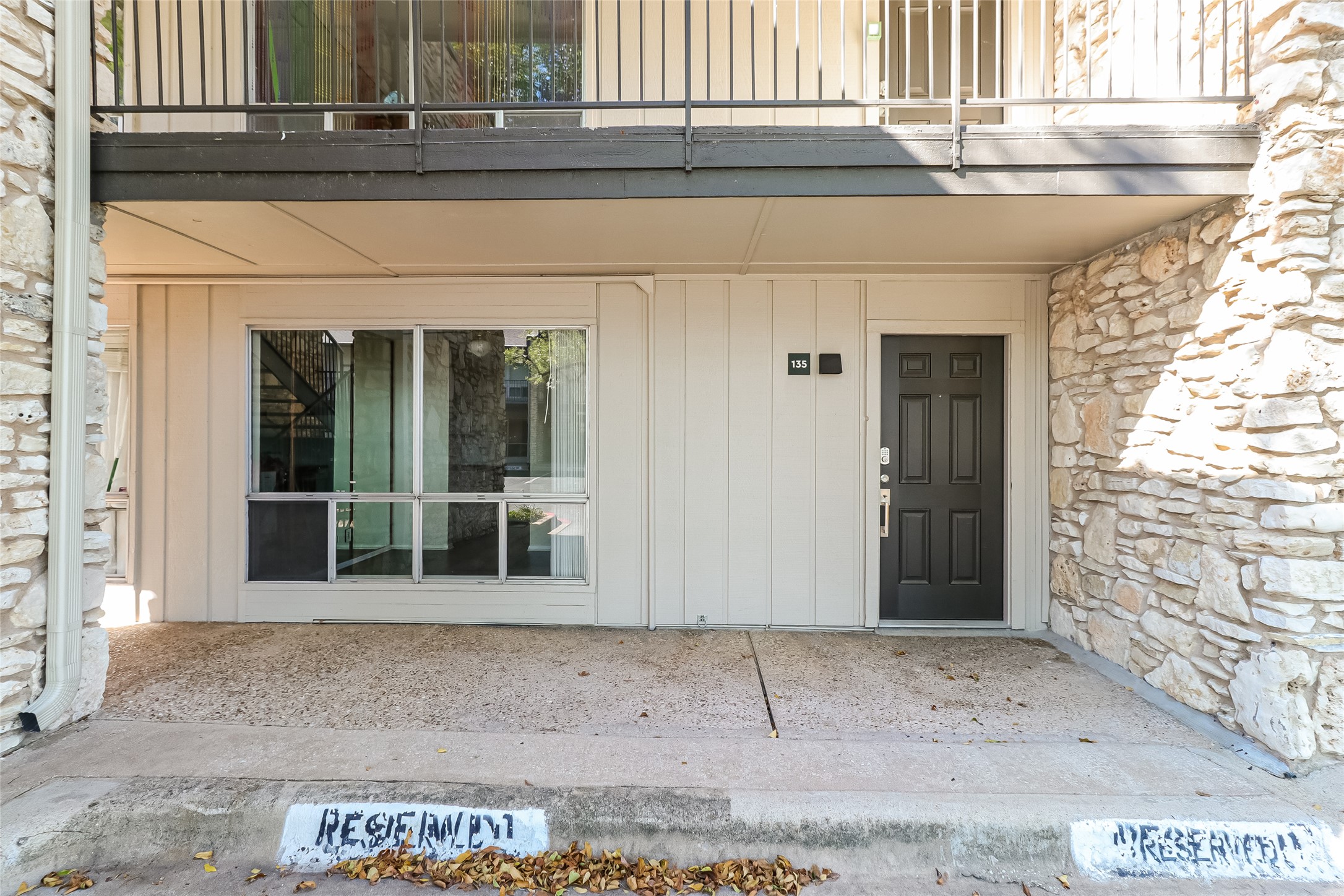 Doorway to property with stone siding and board and batten siding