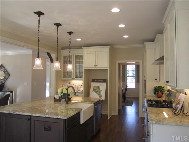 7012 Carries Reach Way Raleigh, NC 27614 - Photo 3 of 5 a kitchen with sink refrigerator and cabinets