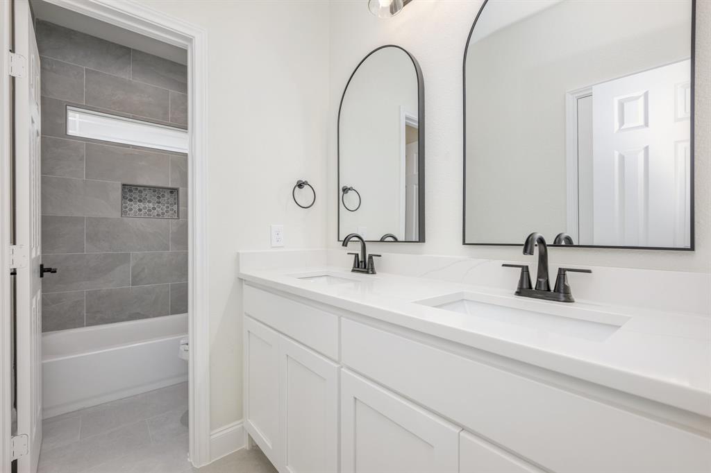 1844 County Road 2320 Terrell, TX 75160 - Photo 10 of 27 a bathroom with a double vanity sink and a mirror