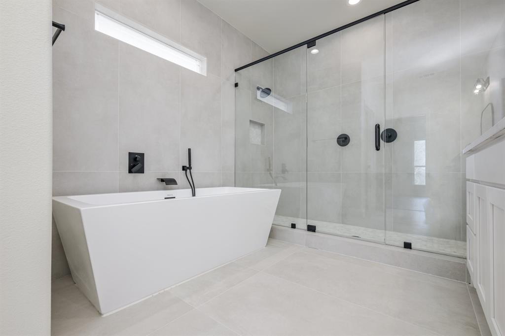 1844 County Road 2320 Terrell, TX 75160 - Photo 15 of 27 a bathroom with a white bath tub sitting next to shower