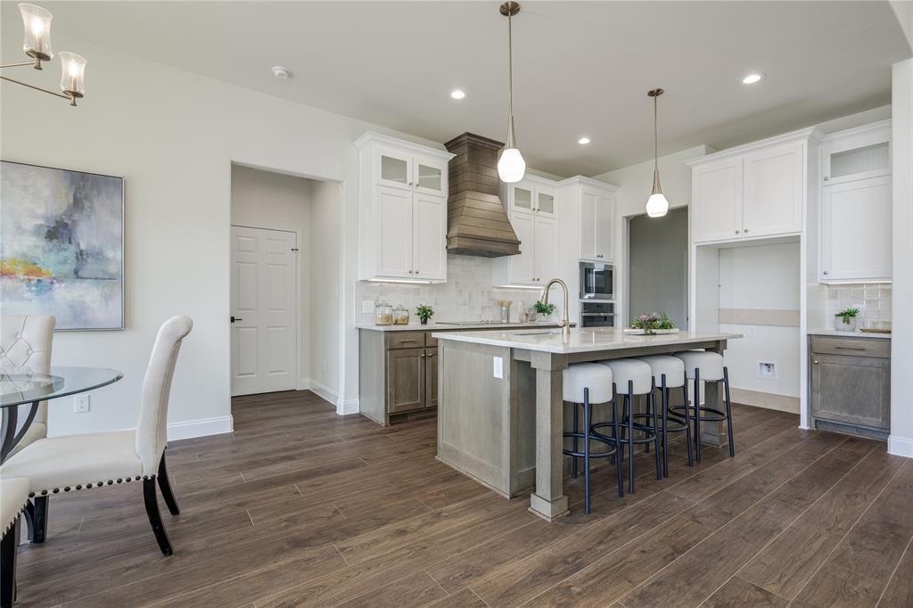 1844 County Road 2320 Terrell, TX 75160 - Photo 26 of 27 a kitchen with kitchen island a dining table chairs stainless steel appliances and cabinets