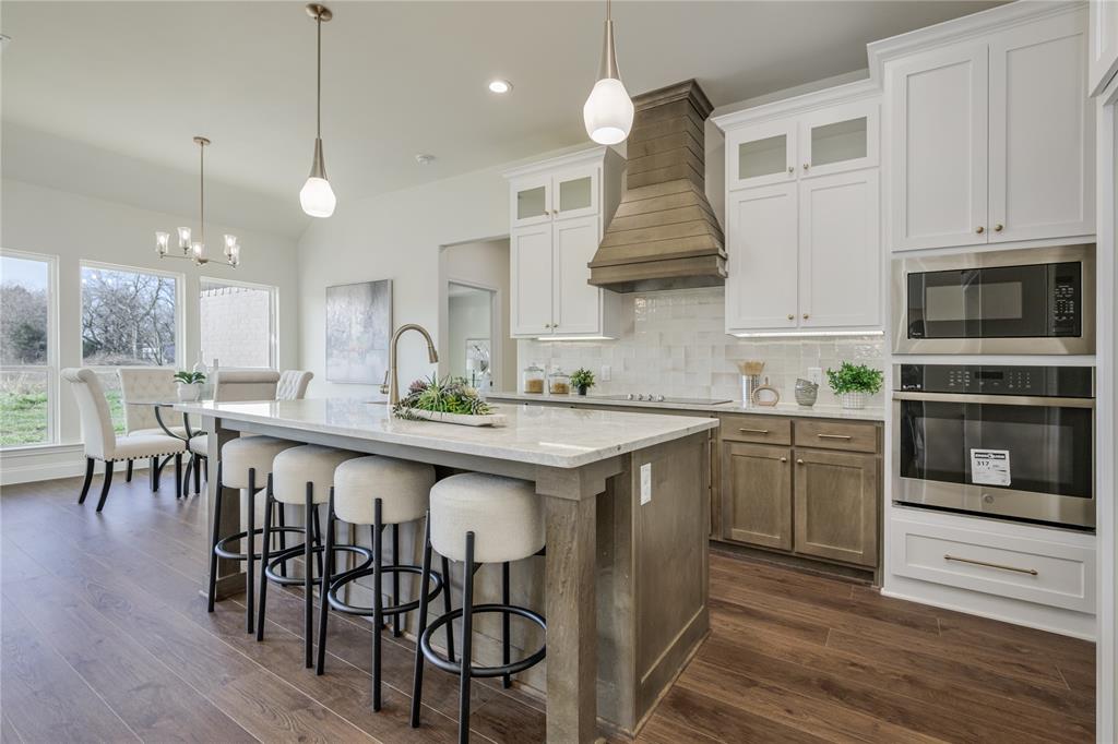 1844 County Road 2320 Terrell, TX 75160 - Photo 27 of 27 a kitchen with a table chairs microwave and cabinets