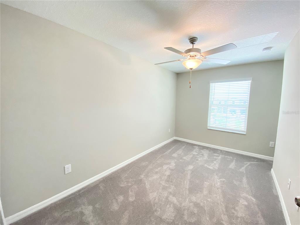 3523 Bellmeade Court Wesley Chapel, FL 33543 - Photo 11 of 22 an empty room with windows and fan