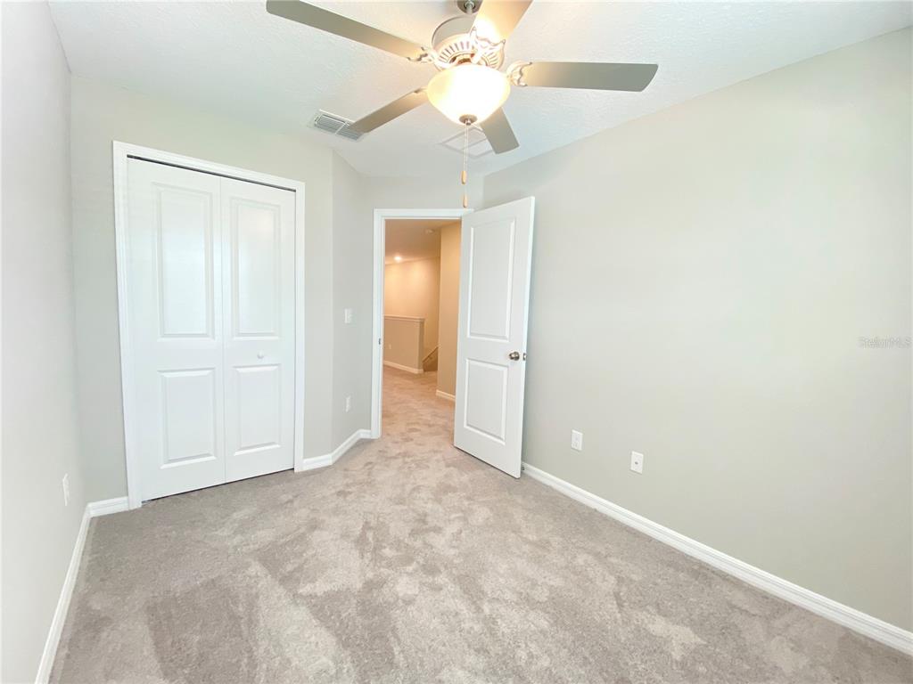 3523 Bellmeade Court Wesley Chapel, FL 33543 - Photo 15 of 22 an empty room with a ceiling fan and a window
