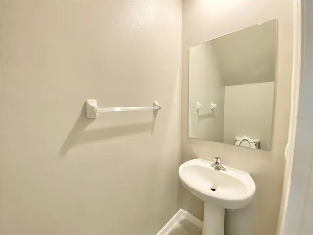a bathroom with a sink a mirror and a shower
