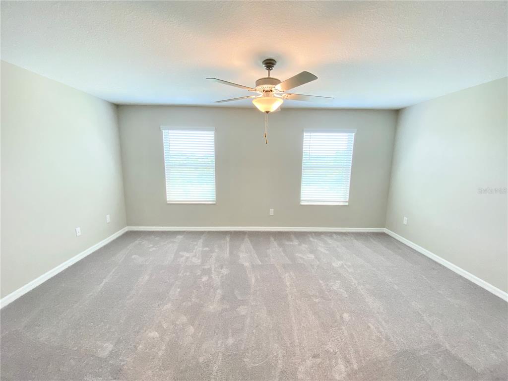 3523 Bellmeade Court Wesley Chapel, FL 33543 - Photo 8 of 22 an empty room with windows and fan