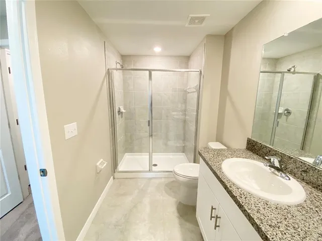 a bathroom with a sink double vanity and shower