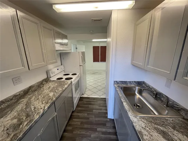 a kitchen with a stove and a refrigerator