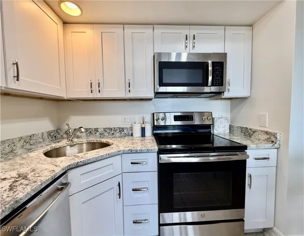 a kitchen with a stove and a microwave