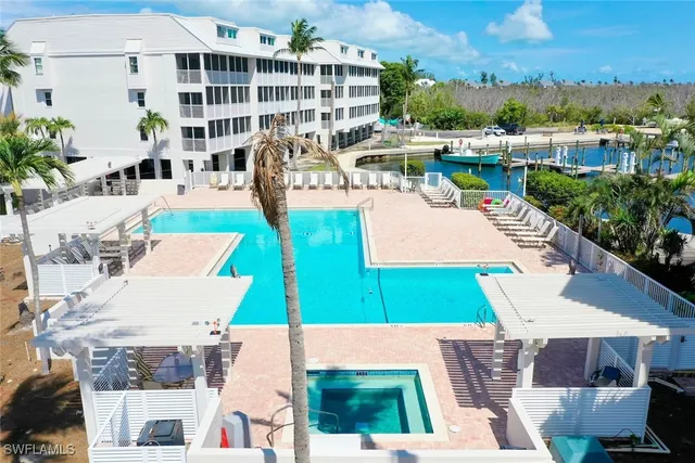 an aerial view of a house with outdoor space and lake view