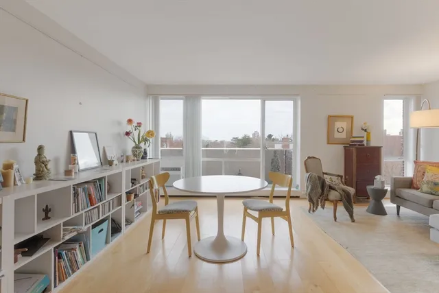 a dining room with furniture and wooden floor