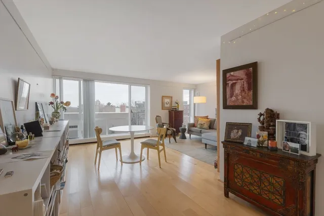 a living room with furniture large window and a table