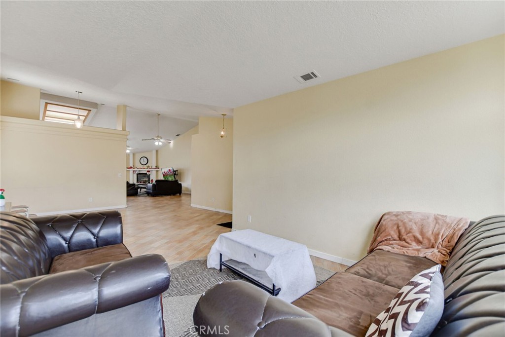 12794 Rain Shadow Road Victorville, CA 92395 - Photo 12 of 50 a living room with furniture and a couch