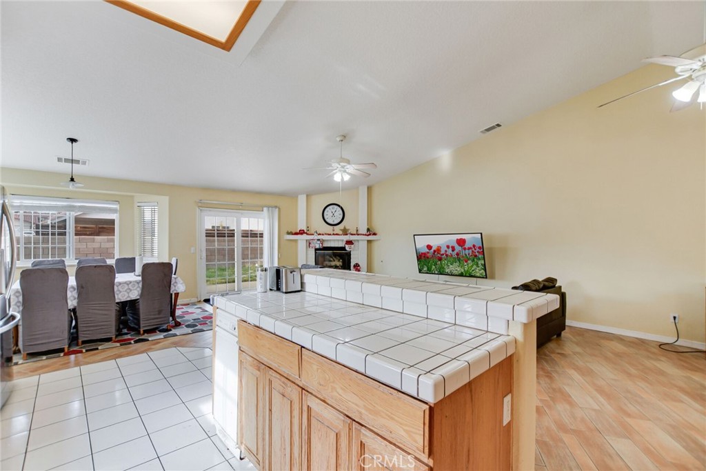 12794 Rain Shadow Road Victorville, CA 92395 - Photo 18 of 50 a living room with kitchen island furniture and a table