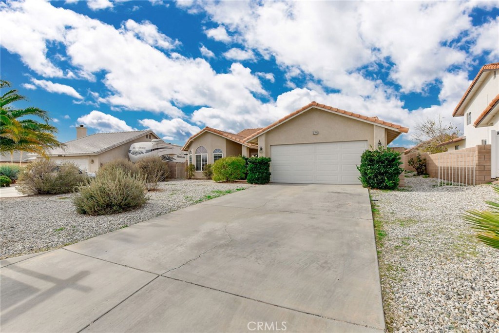 12794 Rain Shadow Road Victorville, CA 92395 - Photo 2 of 50 a view of a house with a yard and large tree