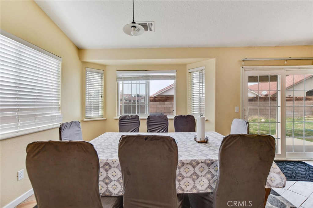 12794 Rain Shadow Road Victorville, CA 92395 - Photo 24 of 50 a living room with furniture and large windows